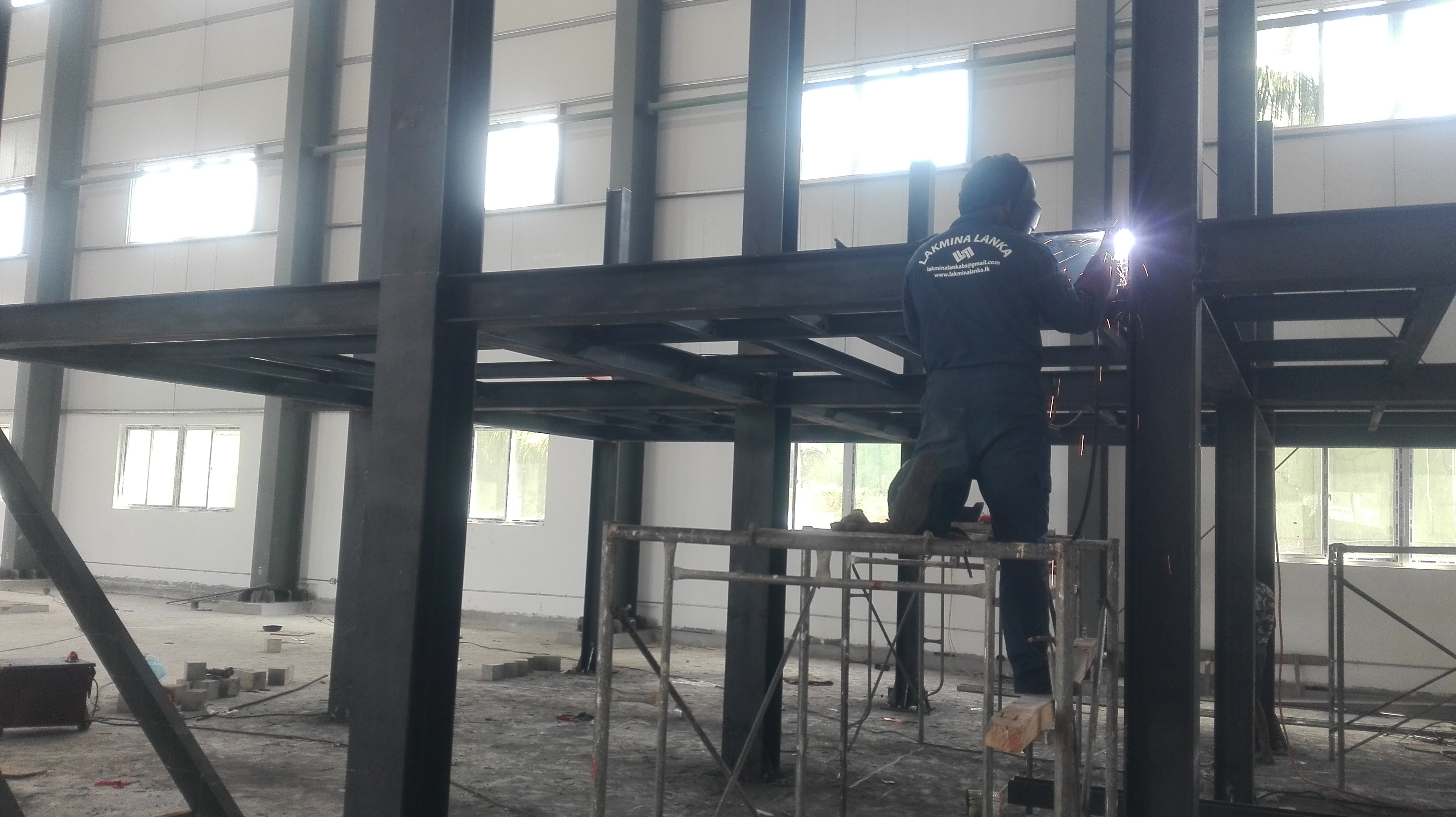 Orange construction truck on a gravel road.